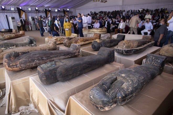 Ancient coffins are displayed at the Saqqara archaeological site, 30 kilometers (19 miles) south of Cairo, Egypt on Saturday, Oct. 3, 2020. Egypts ministry of antiquities and tourism says at least 59 sealed sarcophagi with mummies inside were found that had been buried in three wells more than 2,600 years ago. (AP Photo/Mahmoud Khaled)